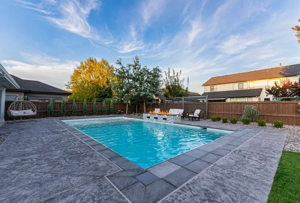 Backyard pool with spa and stamped concrete deck