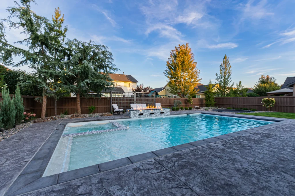 Backyard pool with spa and stamped concrete deck