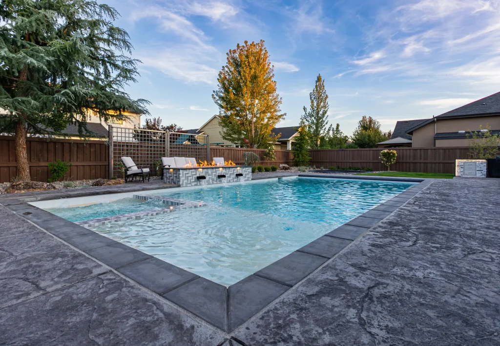 Backyard pool with spa and stamped concrete deck