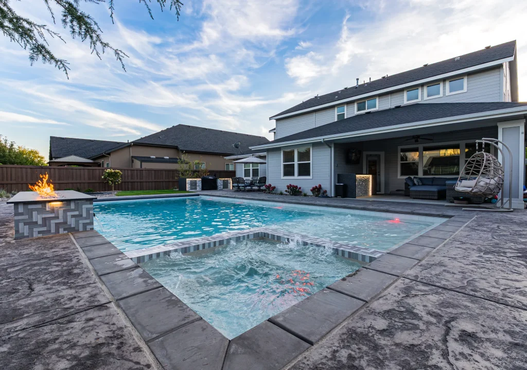 Pool with a linear fire feature beside the water