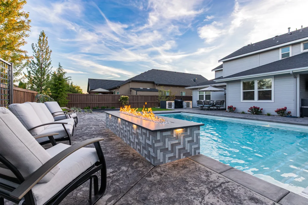 Pool with a linear fire feature beside the water