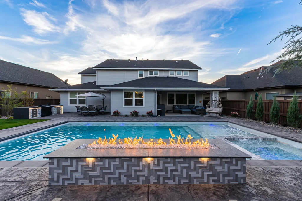Pool with a linear fire feature beside the water