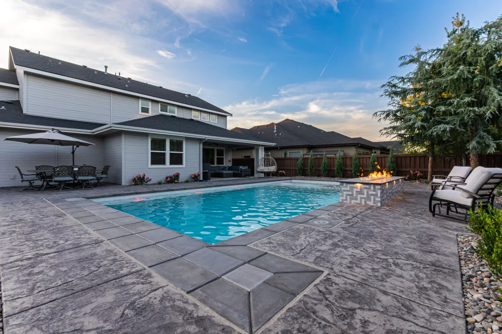 Pool with a linear fire feature beside the water