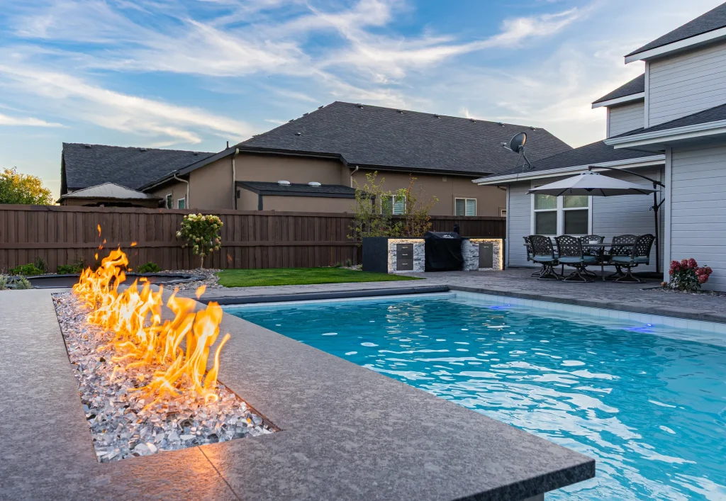 Pool with a linear fire feature beside the water