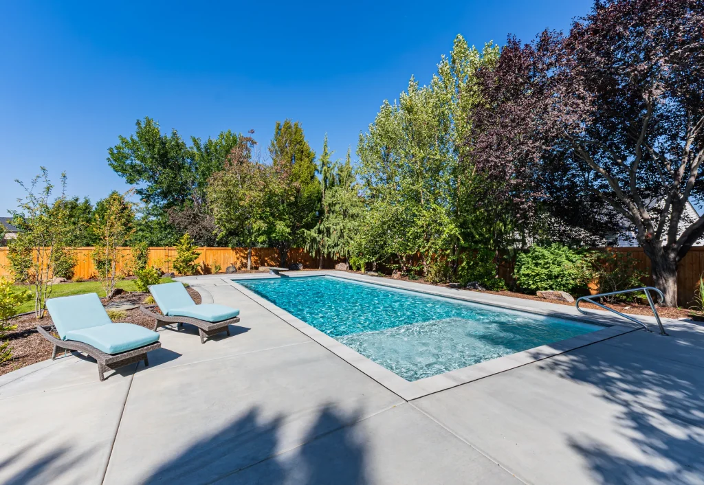 Pool with sun loungers on a wide concrete deck