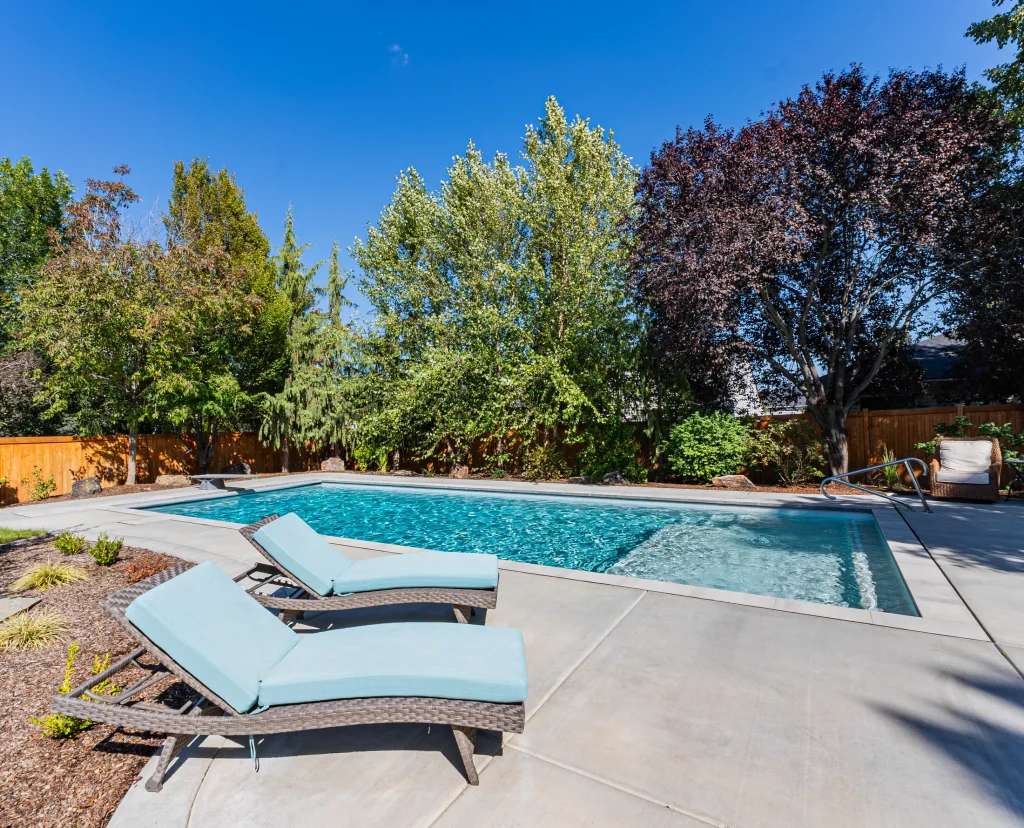 Pool with sun loungers on a wide concrete deck