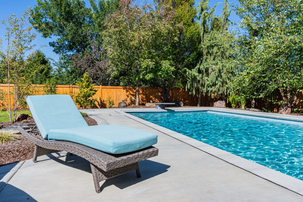 Pool with sun loungers on a wide concrete deck