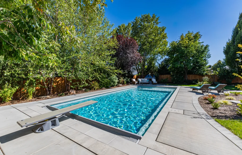 Pool with sun loungers on a wide concrete deck