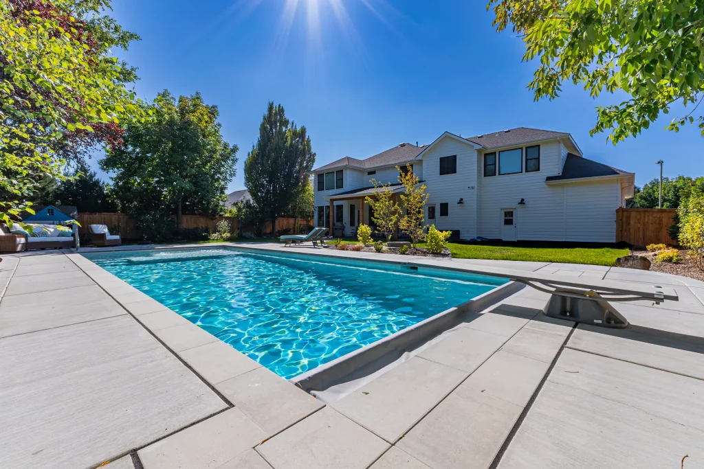 Pool with sun loungers on a wide concrete deck