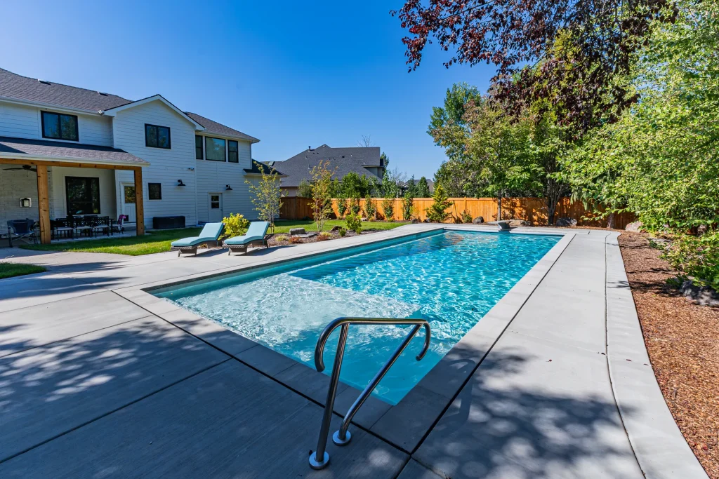 Pool with sun loungers on a wide concrete deck