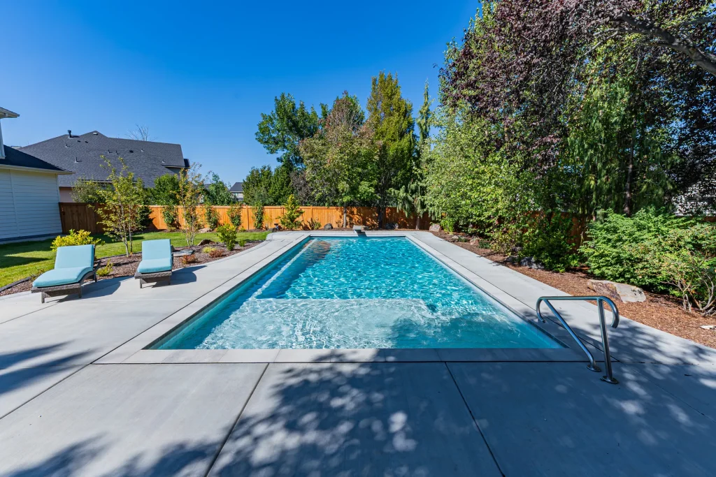 Pool with sun loungers on a wide concrete deck