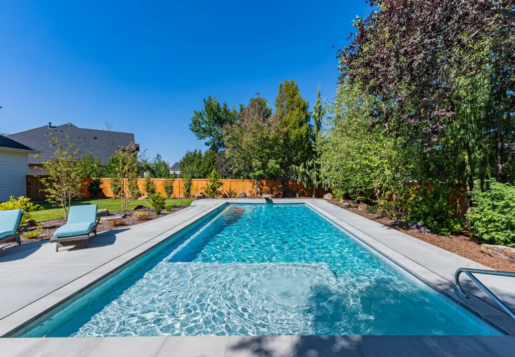 Pool with sun loungers on a wide concrete deck