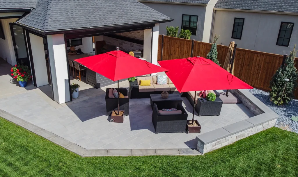 Covered patio with lounge seating next to the pool