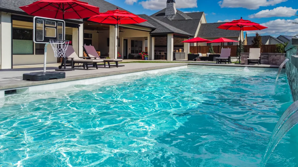 Covered patio with lounge seating next to the pool