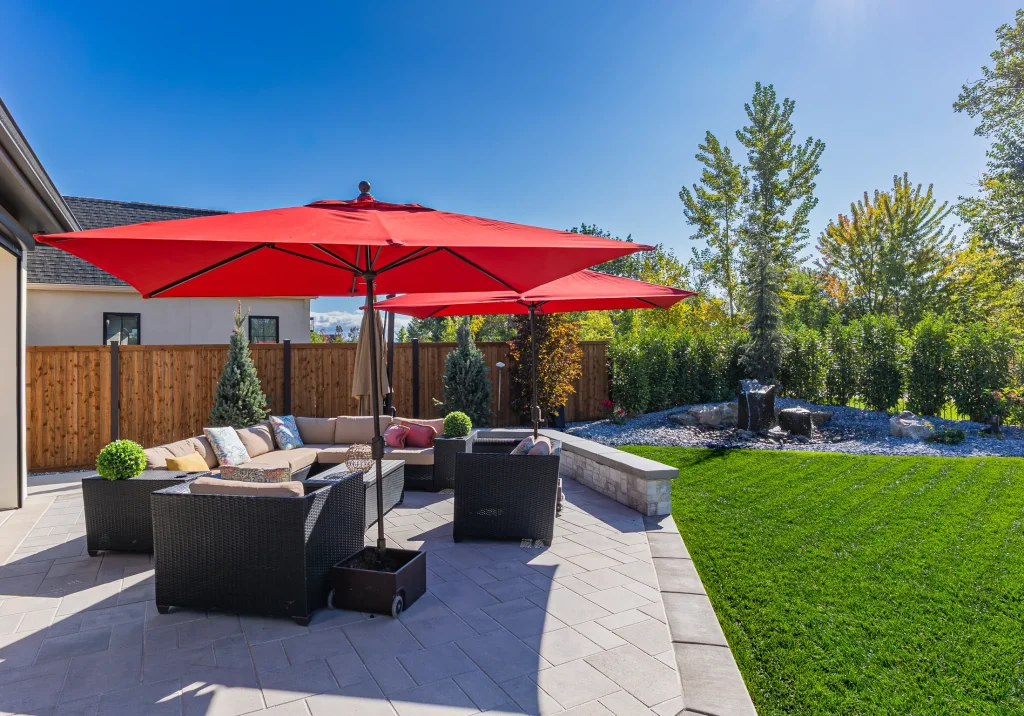 Covered patio with lounge seating next to the pool