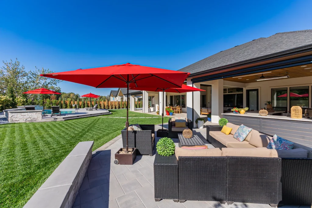 Covered patio with lounge seating next to the pool