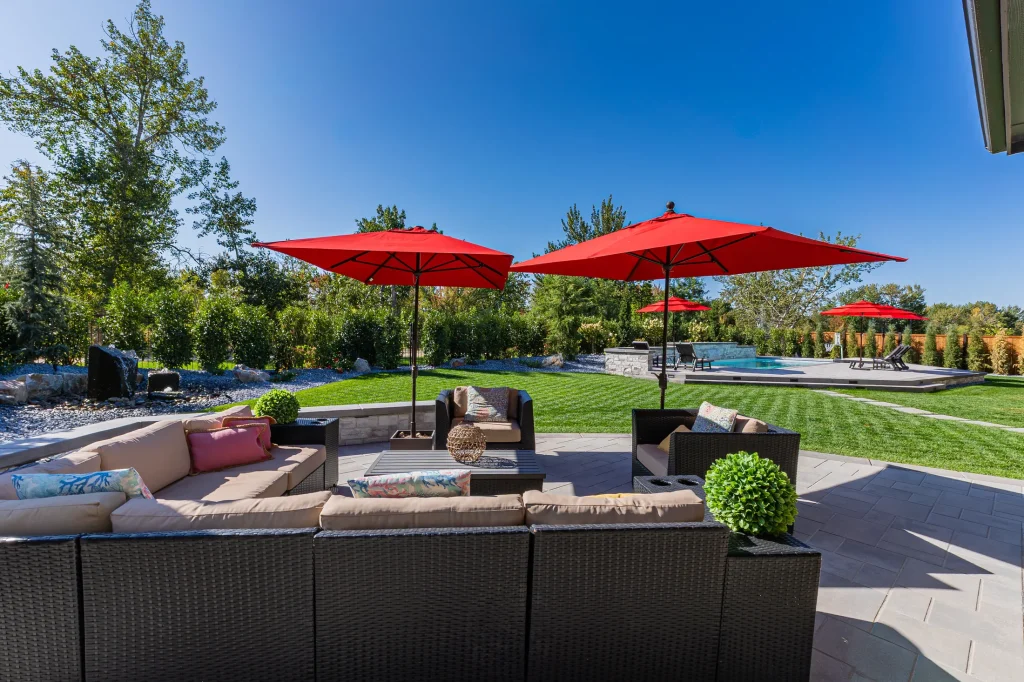 Covered patio with lounge seating next to the pool