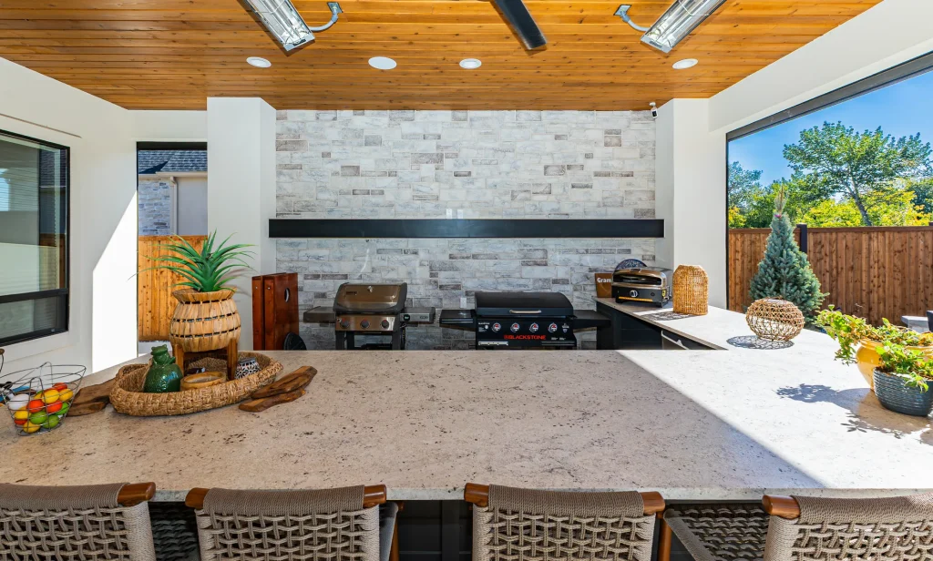 Outdoor kitchen with a stone feature wall