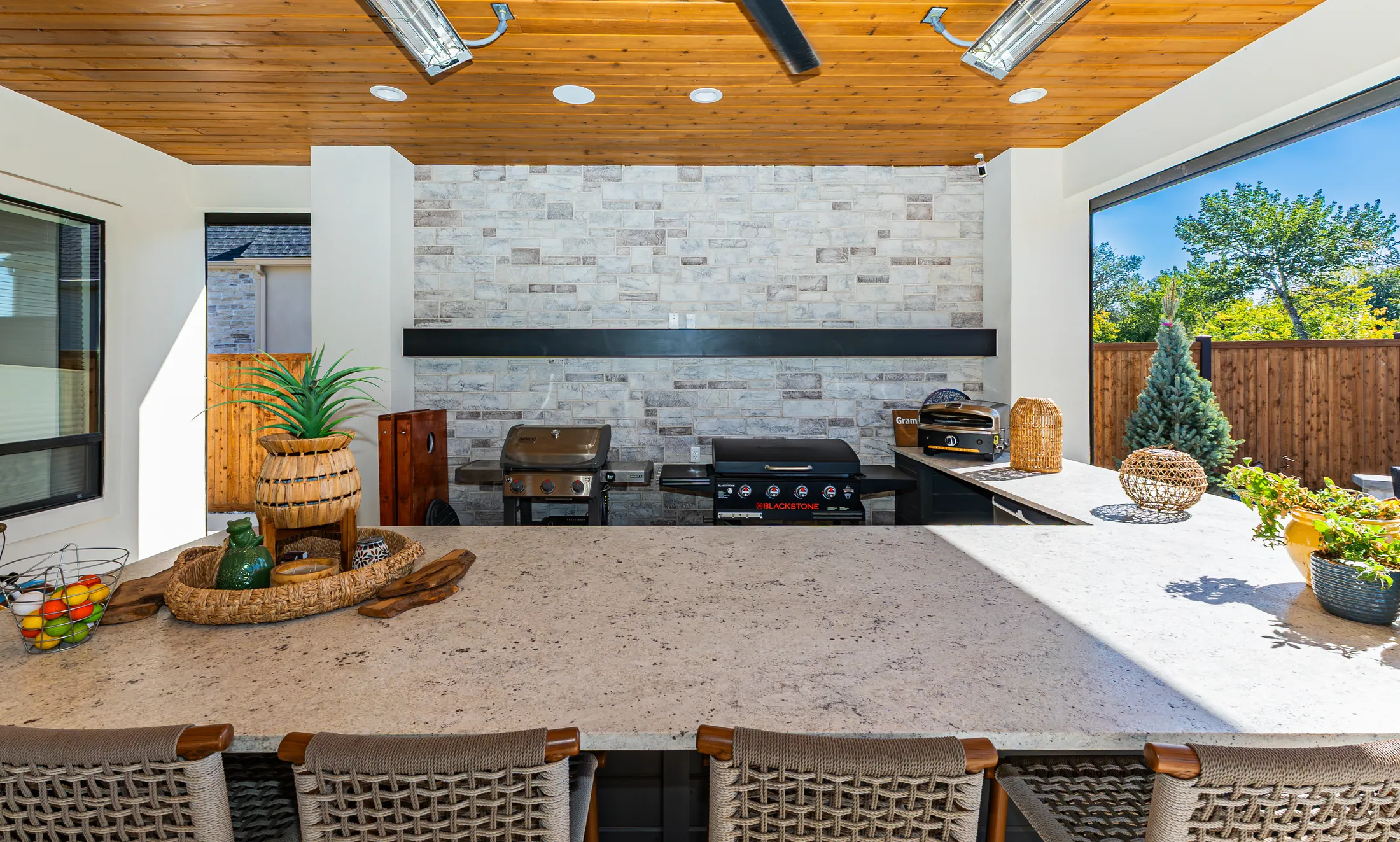 Outdoor kitchen with a stone feature wall