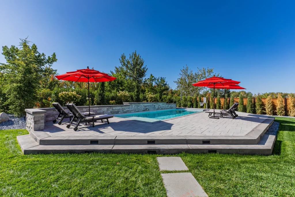 Pool with stone feature wall and sun deck