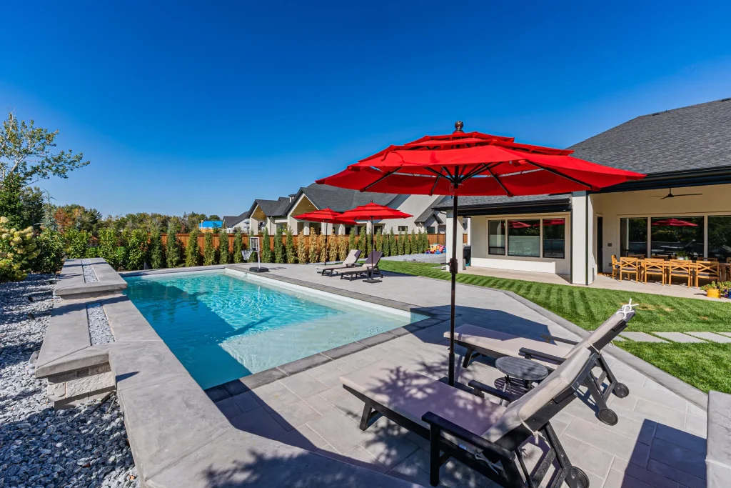 Pool with stone feature wall and sun deck