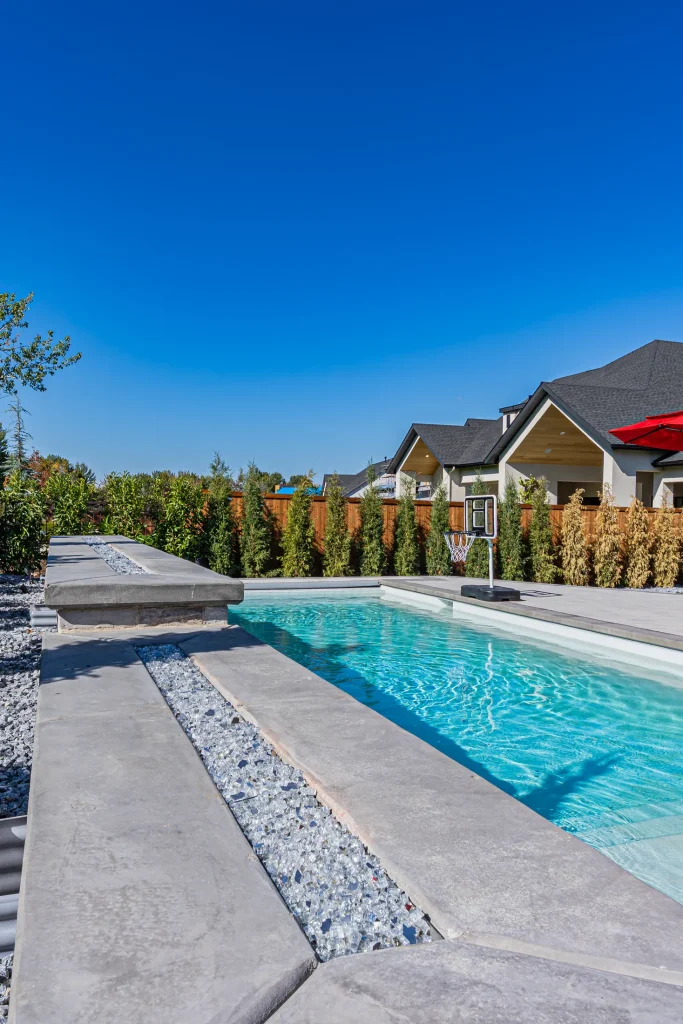 Pool with stone feature wall and sun deck