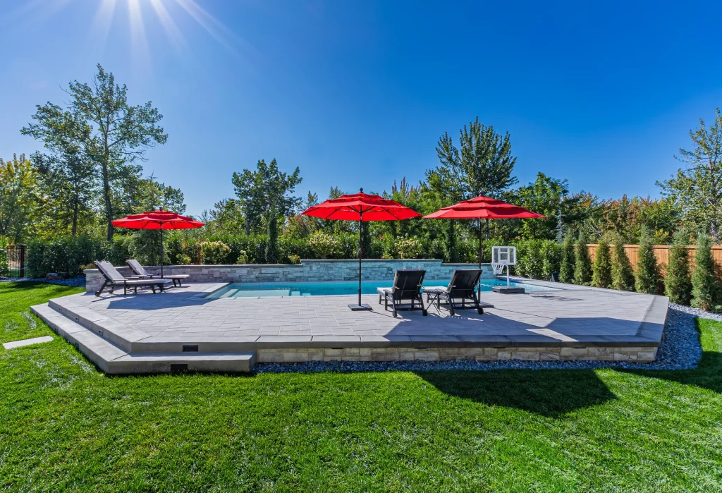 Pool with stone feature wall and sun deck