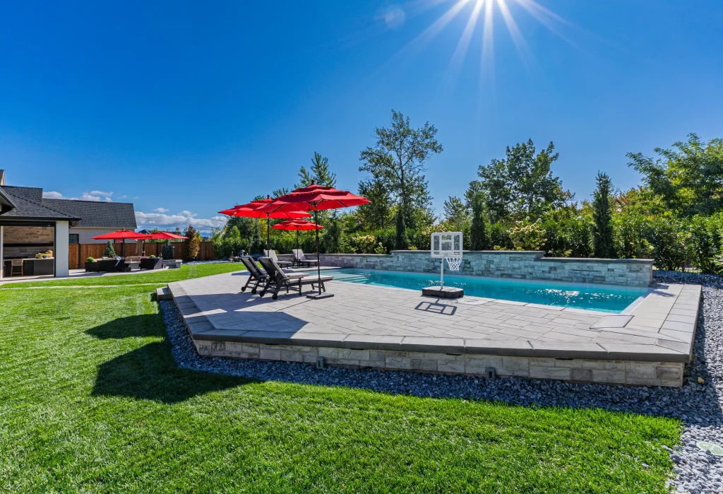 Pool with stone feature wall and sun deck