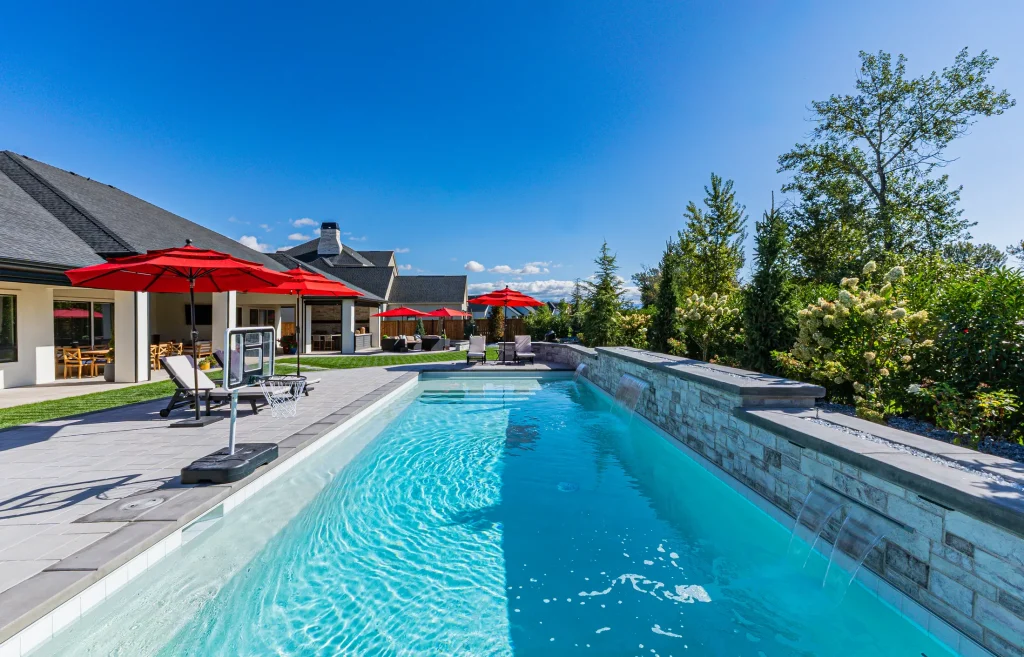 Pool with stone feature wall and sun deck
