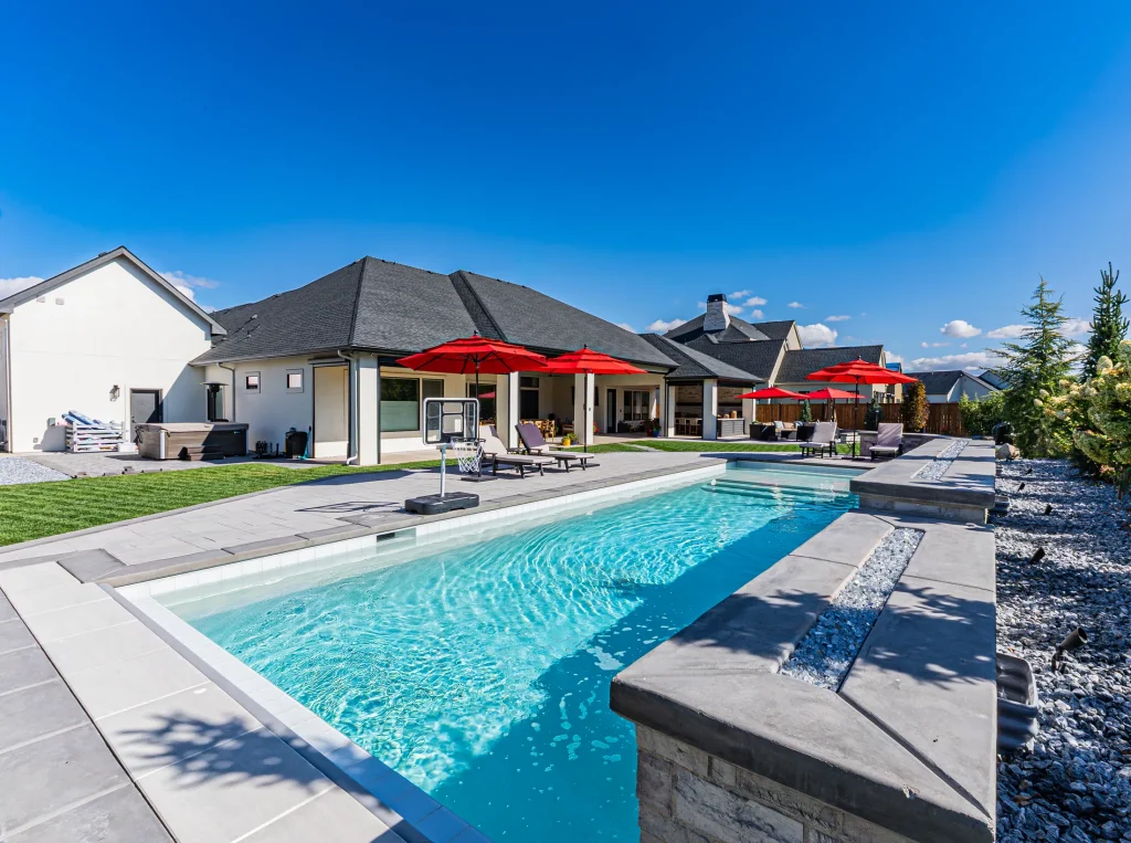 Pool with stone feature wall and sun deck