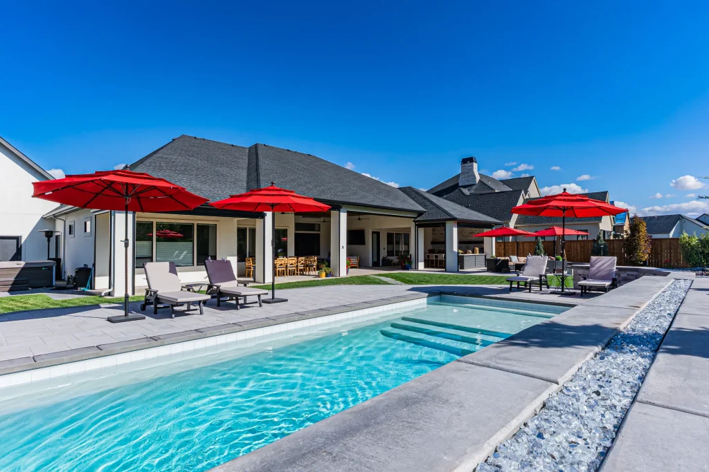 Pool with stone feature wall and sun deck