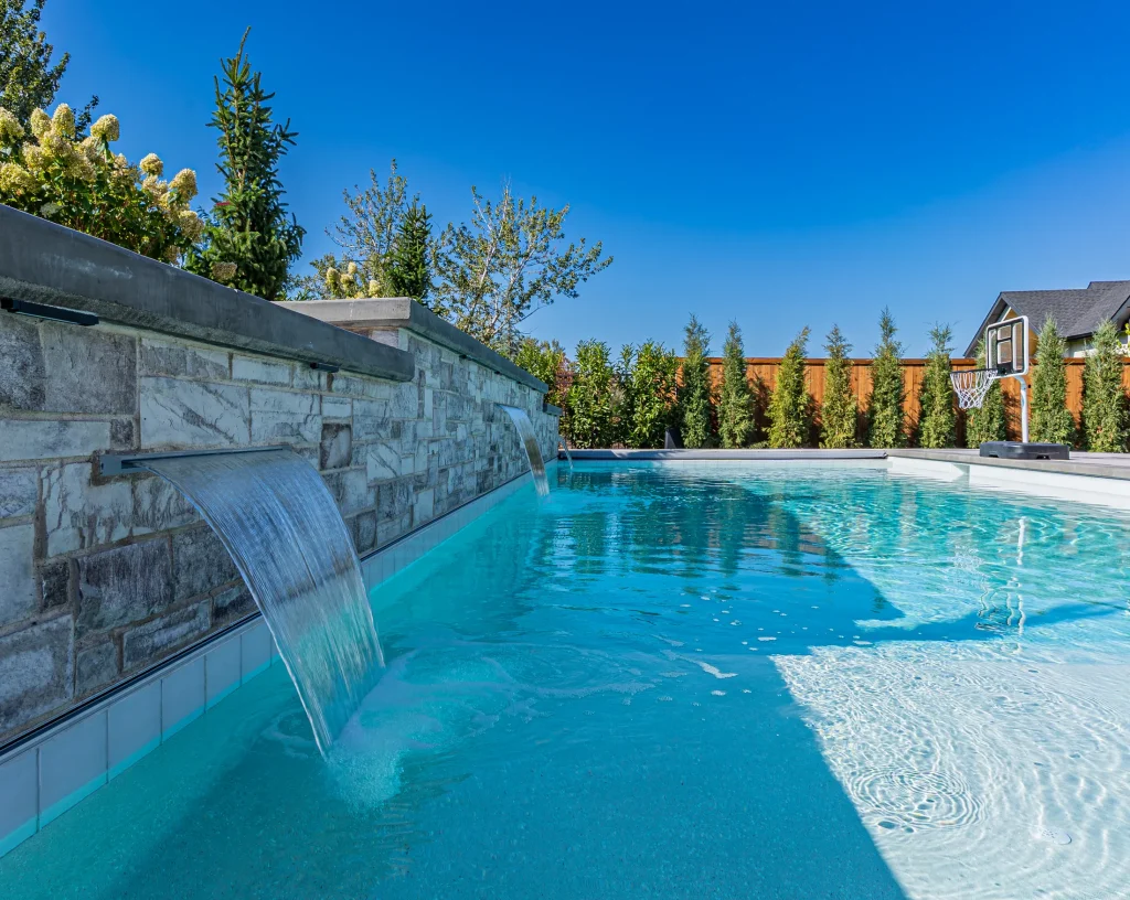 Pool with stone feature wall and sun deck