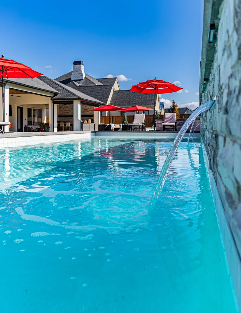 Pool with stone feature wall and sun deck