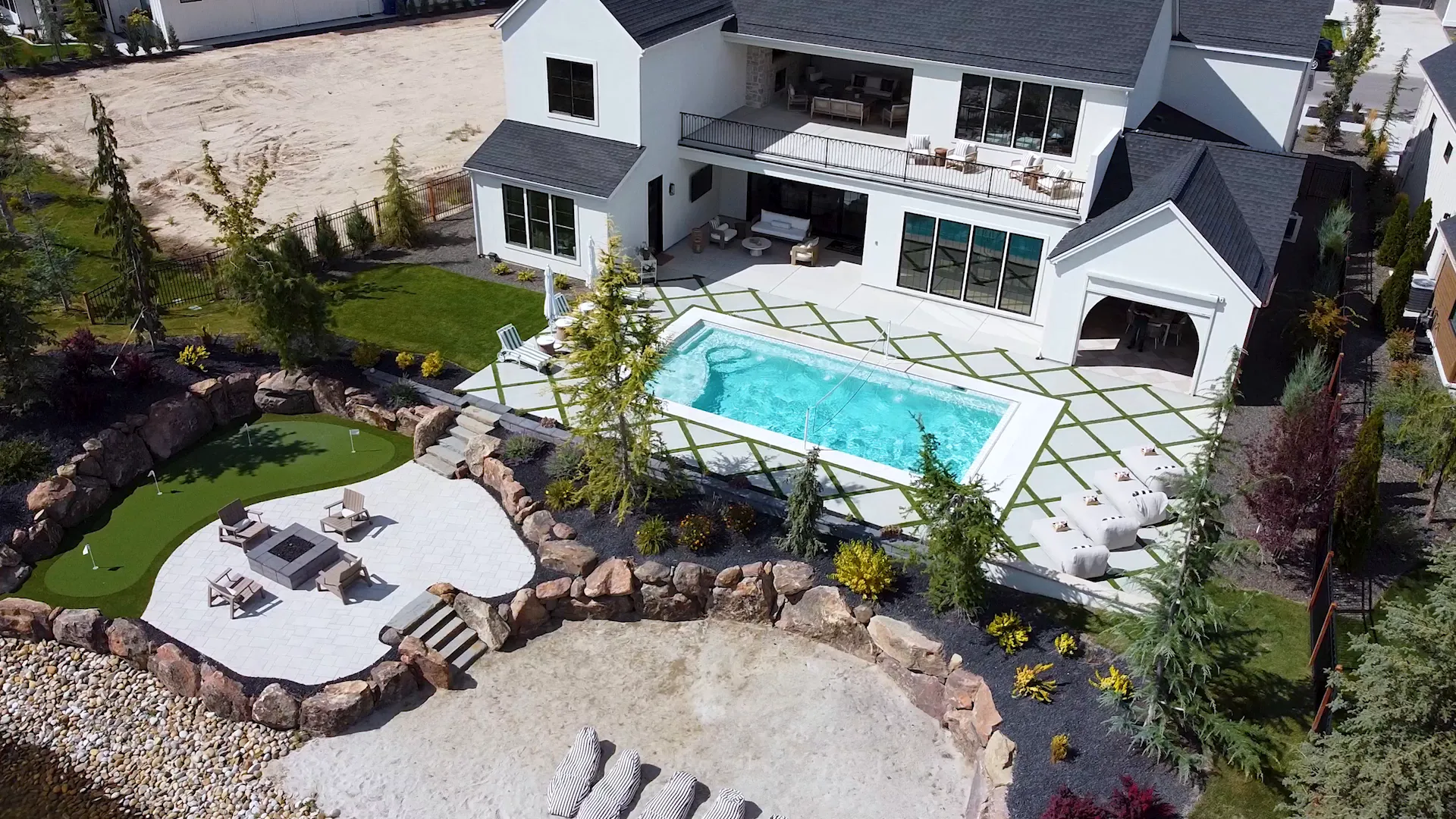 Aerial view of a pool and terrace near the water